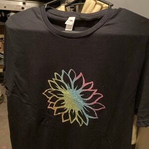 A black shirt with a sunflower